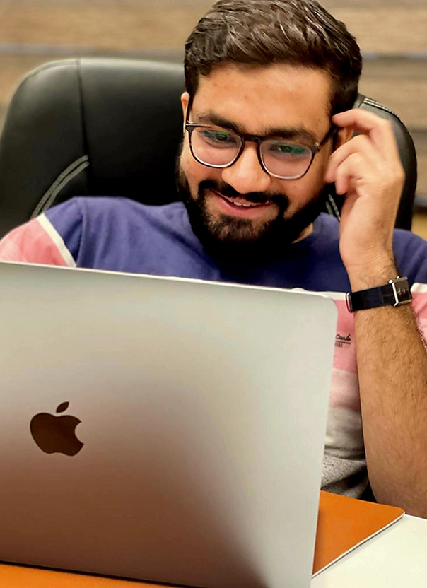 Keshin Javiya working on a MacBook